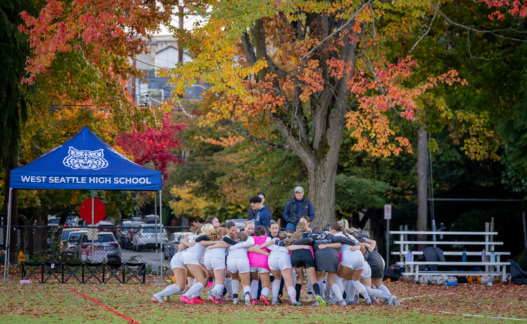 West Seattle Girls Soccer Team gathered in a circle for a cheer.